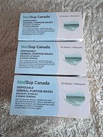 Three boxes of MedSup Canada disposable masks, front packaging visible