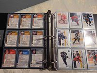 Binder open with hockey card backs and fronts