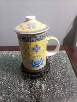 Assembled mug on wooden stand showing exterior pattern