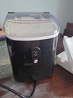 Front view of Aglucky ice maker showing lid and control panel