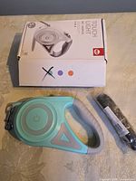 Front of box with leash and spare strap