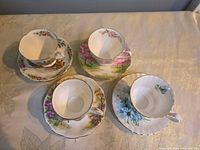 Four Royal Albert teacups on matching saucers, overhead view