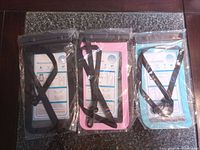 Front view of all three sealed waterproof phone pouches in black, pink, blue
