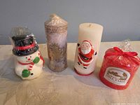 Front view of all four candles standing side by side