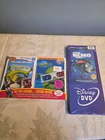 Front view of both sealed DVD cases: Shrek with 3D glasses visible, Finding Nemo slipcover