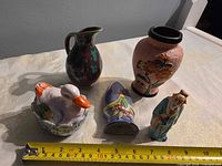 All five ceramic items with ruler for scale