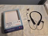 Amplifier, box, USB cable, ear tips laid out