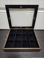 Lid open showing 12 felt-lined compartments