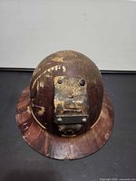 Top/front view showing brown Bakelite hard hat and metal lamp bracket