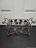 Front view of rectangular wrought iron tray showing leaf details and handles