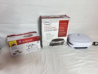 Group shot of all three boxed/shelled appliances