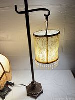 Full view of adjustable hanger lamp showing stand and cylindrical shade