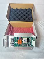 PCB assembly in open box with foam lining