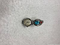 Front view showing Bulova dial and sterling silver cover with turquoise and coral stones