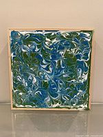 Front view of acrylic pour painting showing marbled design