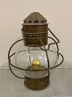 Front view of brass and glass ship lantern showing overall form