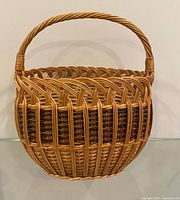 Front view of round wicker basket with handle