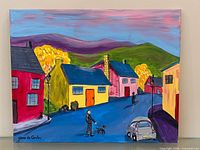 Full view of acrylic painting on canvas showing colorful village street scene