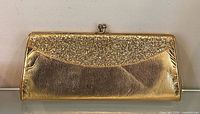 Full front view of gold glitter envelope clutch