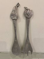 Front view of both salad utensils showing pear and apple handles