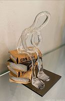 front left view showing plexiglass figure and book titles Civil Law, Torts