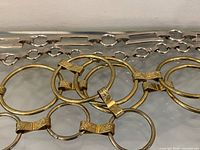 Close-up of gold-tone ring belt overlaid on silver-tone bar link belt