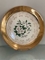 Front view of entire plate showing floral design and gold rim