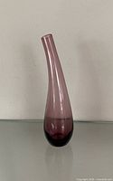 Full view of purple glass teardrop bud vase standing upright