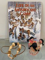 Book front cover with figurine and necklace