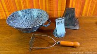 Overall lot showing colander, toaster, funnel, masher