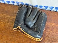 Folded vintage Cooper Weeks glove showing leather condition and lacing