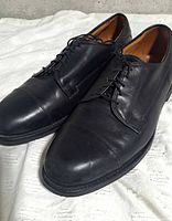 Top angled view of both shoes showing uppers, laces, toe caps