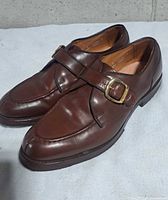 Left side three-quarter view of the pair showing leather condition and buckle