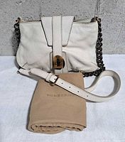 Front view of cream Burberry leather shoulder bag with chain strap, detachable leather strap and dust bag
