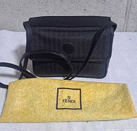 Front view of Fendi black canvas crossbody with dust sleeve