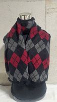Scarf draped on mannequin showing argyle pattern and fringe