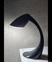 Left-side view of entire lamp showing curved neck and diffuser