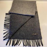 Full view of scarf showing both charcoal and pale grey sides with fringe