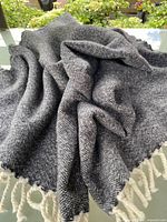 Throw blanket displayed to show overall fabric and fringe