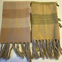 Front view of both tea towels showing colors, pattern and fringe