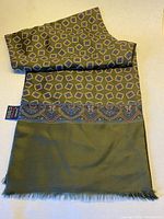 Full view of scarf showing patterned silk side and solid wool side