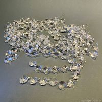 Pile of clear octagonal glass prisms linked with metal rings