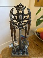 Full view of metal stand with four utensils hanging