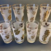 Eight frosted glasses arranged in two rows showing designs and sizes