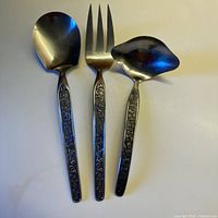 Full view of serving spoon, fork, and gravy spoon