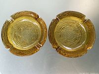 Pair of amber glass ashtrays top view