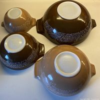 All four nested Pyrex Woodland bowls inverted to show pattern and size range