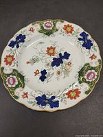Front view showing full floral design and scalloped gilt rim