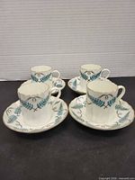 Group view of all four cups with saucers