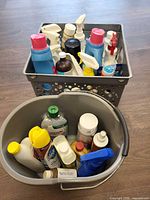 Overall view of pail and crate filled with various cleaning products